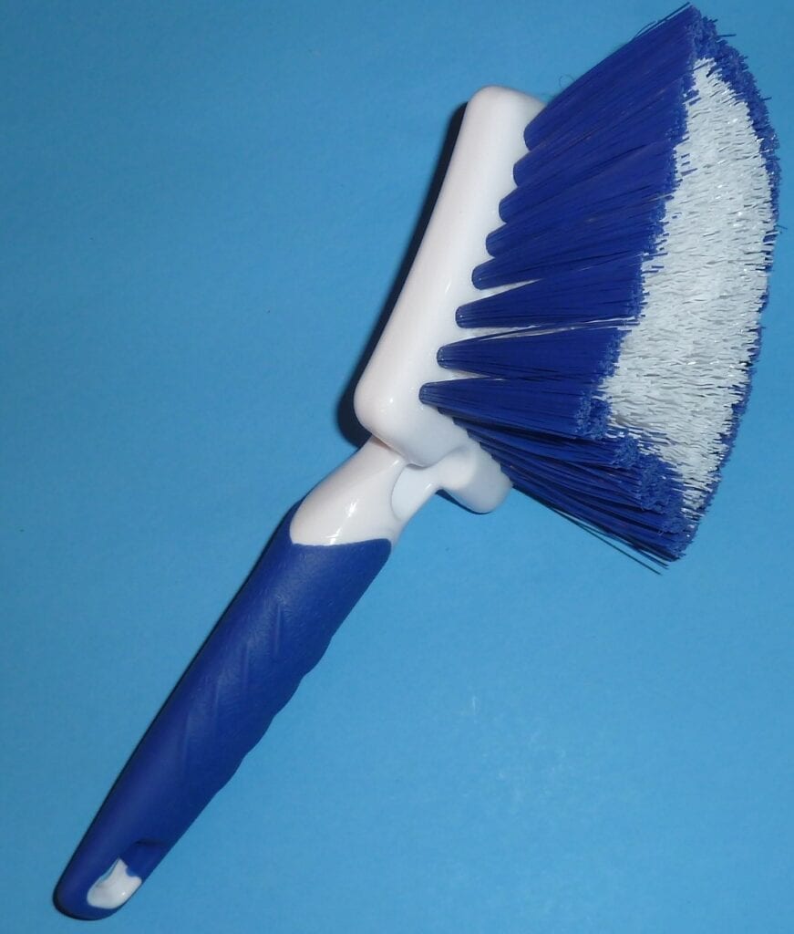Blue and white cleaning brush with angled handle.