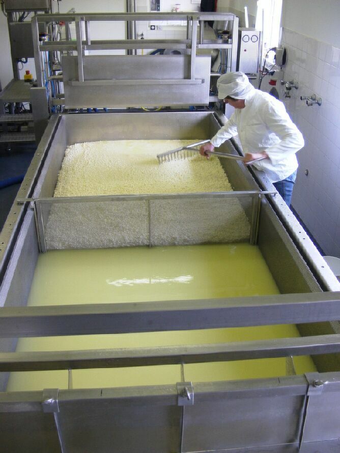 A Person in Overalls With a Pant With a Machine