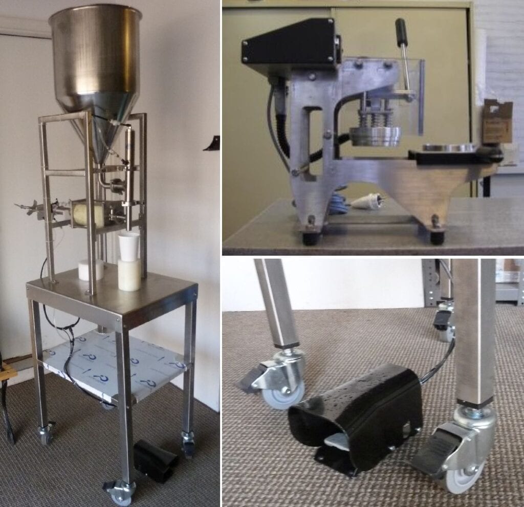 Stainless steel industrial machine with wheels and mechanical components.