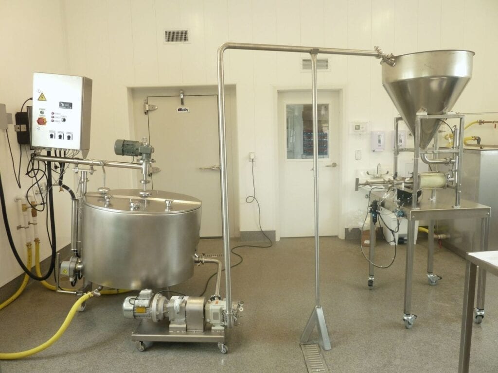 Industrial food processing equipment inside a clean facility.