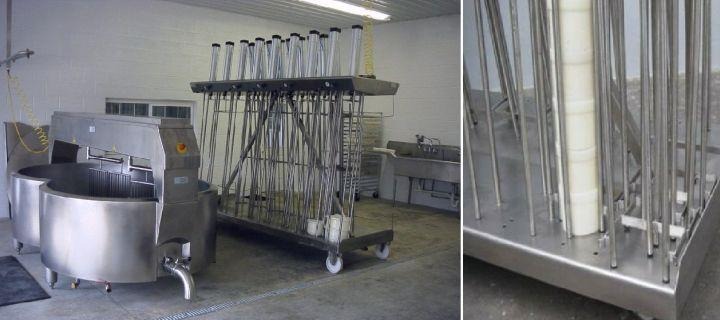 Industrial drying racks with clothes hangers in a warehouse setting.