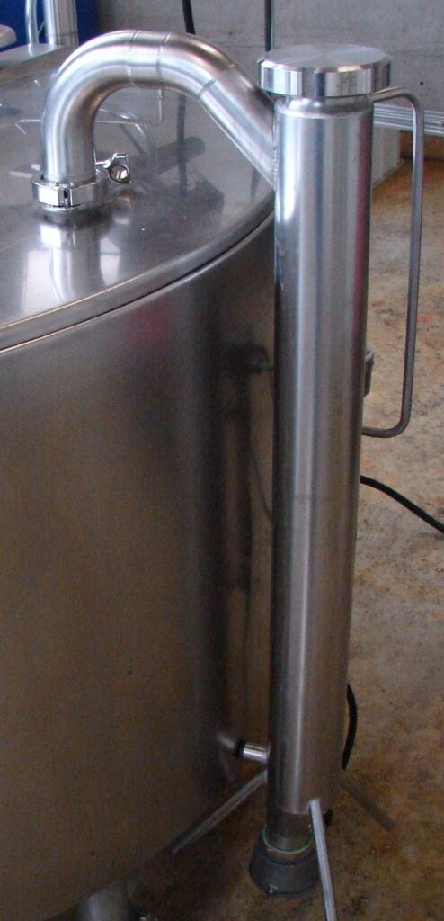 Close-up of a metallic cylindrical object with a handle and a small attached component.