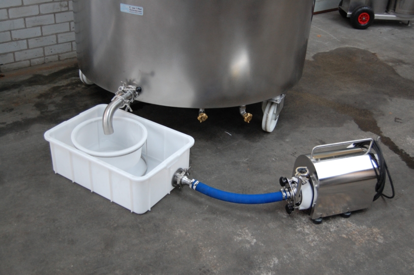 Industrial equipment with a hose transferring liquid into a container.