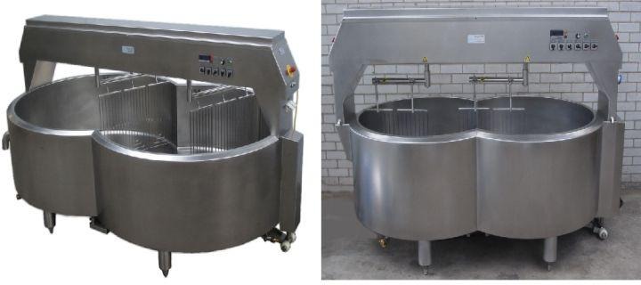 Two large stainless steel industrial cooking kettles with lids and control panels.