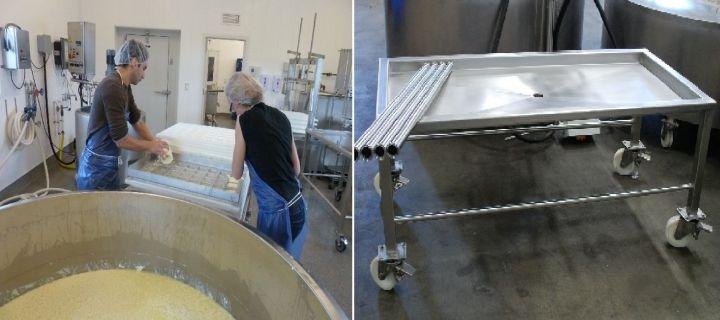 Person working in a large industrial kitchen or food processing area with stainless steel equipment.