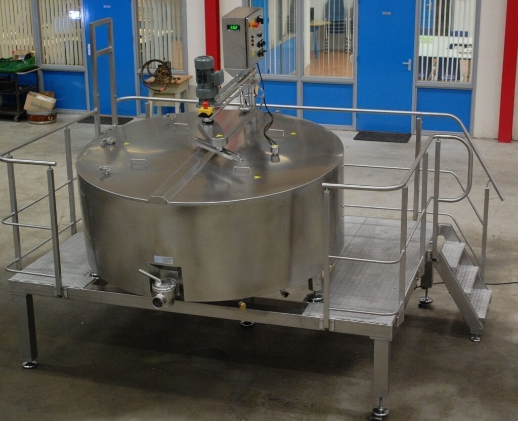 Industrial stainless steel mixing tank in a factory setting.