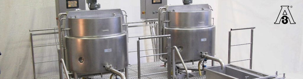 Industrial stainless steel tanks and pipes in a clean processing facility.