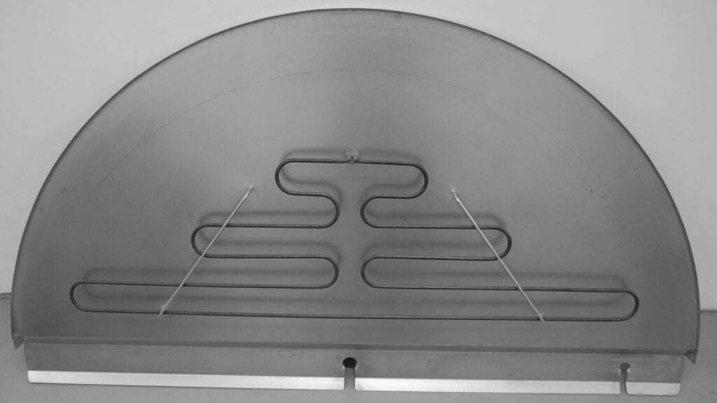 Close-up of a metal heating element under a glass surface.