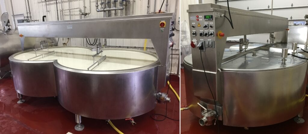 Industrial stainless steel mixing tanks in a food processing facility.