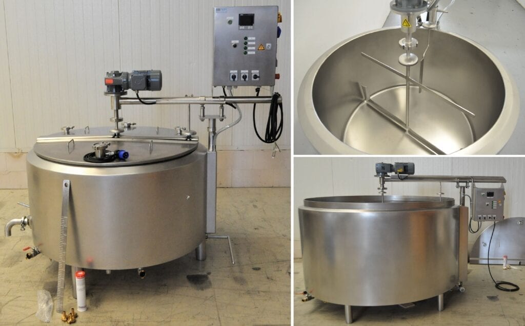 Industrial stainless steel mixing tank with control panel and agitator.